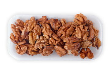 Walnut kernel halfs in a container on white background
