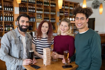 Friends having glass of beer in bar