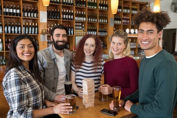 Friends having glass of beer in bar