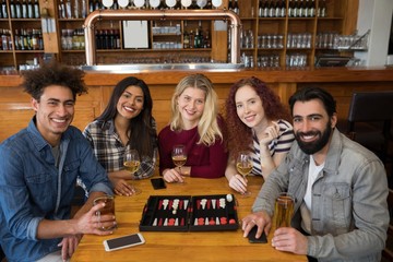 Friends having glass of beer in bar