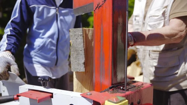 Hydraulic wood splitter big pieces of timber close up 4K