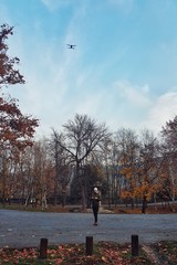 Young man flying a drone in the park