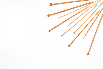 Many wooden knitting needles on white background