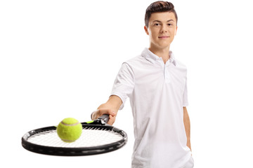 Teen tennis player with a racket and a tennis ball