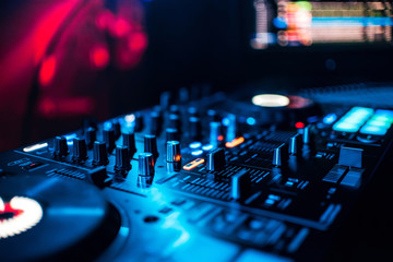 control buttons and mixing music on professional equipment for mixing DJ