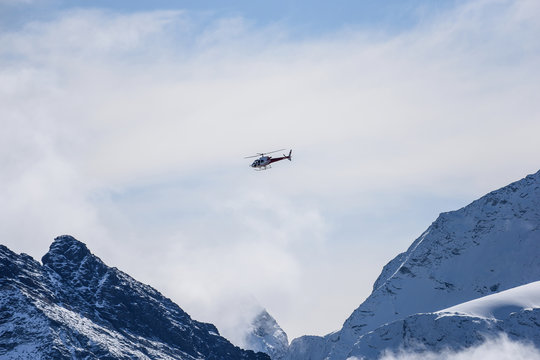 Rescue helicopter fly in Swiss Alps