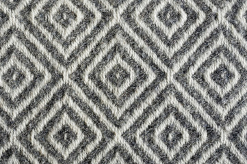 Woolen fabric texture close-up. Gray contrast diamond pattern