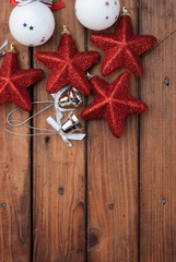 Christmas background with festive decorations on a dark wooden Board, the composition of the Christmas baubles, red sta