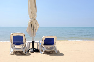 Beach chairs on beautiful sand beach