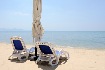 each chairs on beautiful sand beach