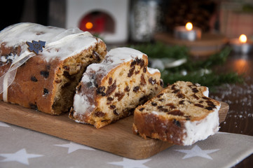 Sliced Christmas Stollen. Traditional german christmas cake with dried fruits and icing sugar