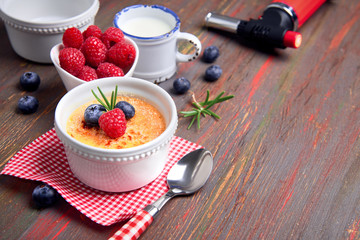Creme brulee with raspberry, blueberry and rosemary with ingredients