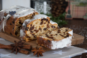 Sliced Christmas Stollen. Traditional german christmas cake with dried fruits and icing sugar