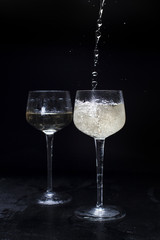  glasses with champagne on a black background