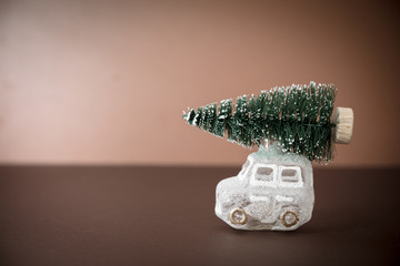 Christmas tree on toy car. Christmas background. Holidays card. Copy space.