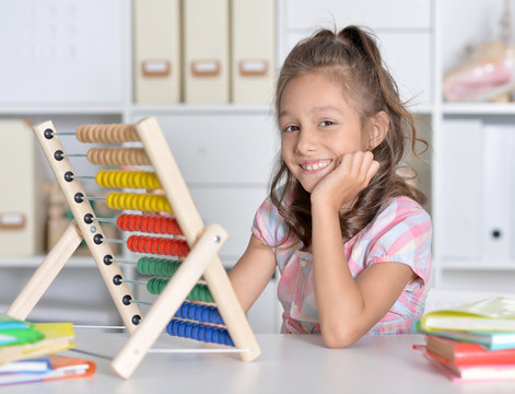 little girl counting on abacus