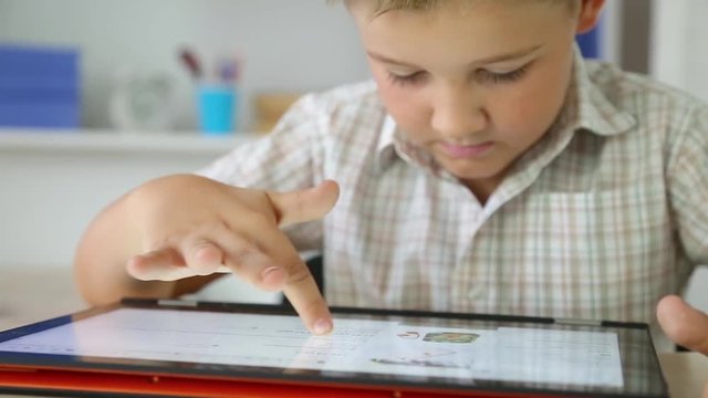 boy uses a multi-touch tablet