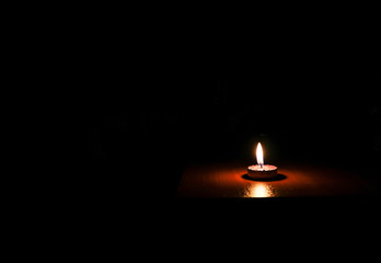 	One Candle light on black background 