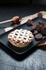 American Pie with cookies and jam. On a black plate