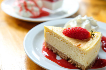 Strawberry cheese pie with fresh strawberry on top in coffee shop in the morning time