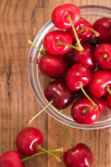 Ripe cherries on wooden table. 