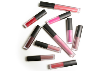 Set of colorful liquid matte lipsticks over a white background