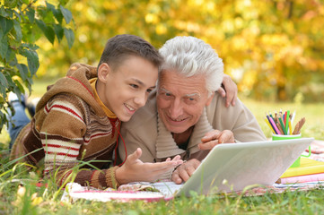 boy and grandfather with  laptop