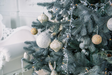 Christmas, new Year tree decorated with garlands and toys in a bright room.  The mood of the...