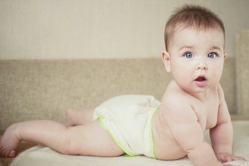 A small child in natural tissue diapers, eco-friendly cotton diapers