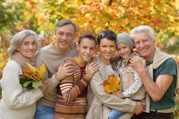 Family relaxing in autumn park