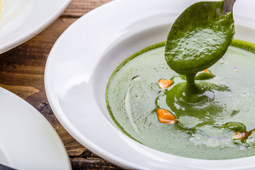 spinach soop spoon close-up salmon