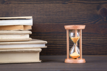 Sandglass, hourglass or egg timer on wooden table showing the last second or last minute or time...
