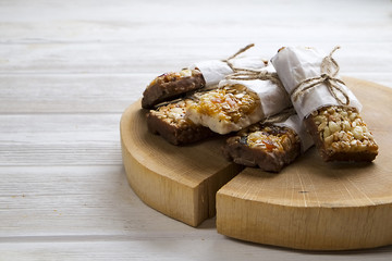 Homemade gluten free granola bars on wooden background. 