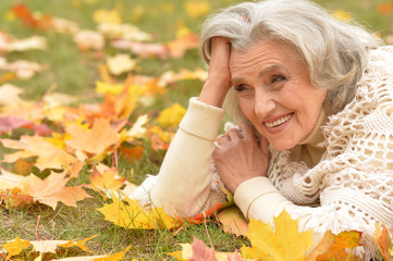 woman holding autumn leaf