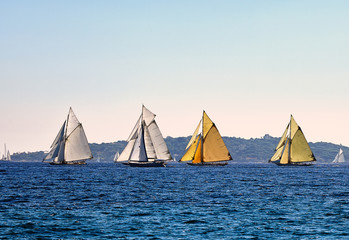 Four old sailboats on sea