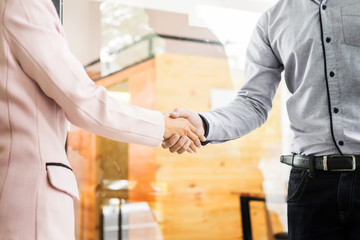 Two confident business man shaking hands during a meeting in the office, success, dealing, greeting and partner concept