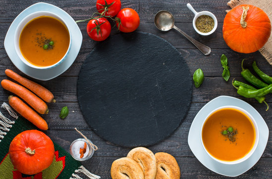 Homemade Pumpkin Soup on rustic wooden background, free space for text.