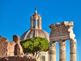 Obraz premium Closeup on columns of Roman Forum with church cupola in Rome, Italy
