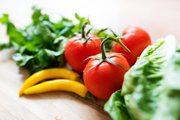 fresh ingredients for green salad on wooden kitchen table