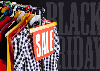Sale in a clothing store - discount sign at a clothes rack.