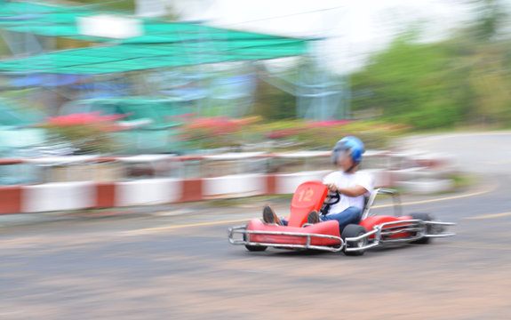 Young man driving to the kart with speed.