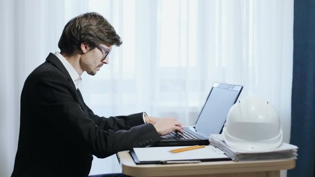 Civil engineer working at a laptop