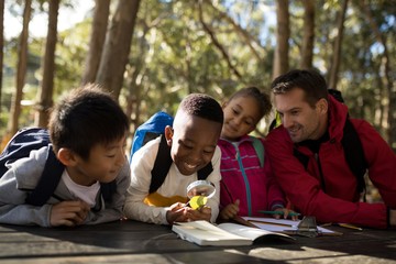 Teacher assisting kids in studying
