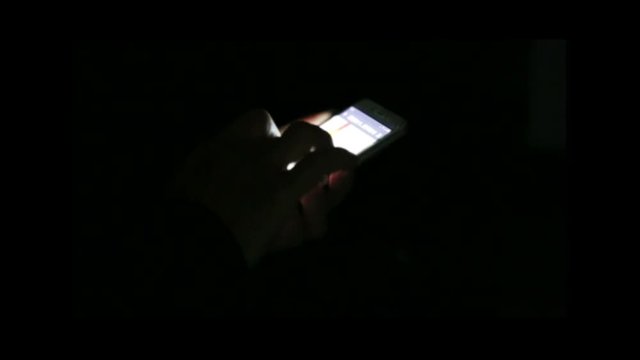 A person using a mobile phone on night