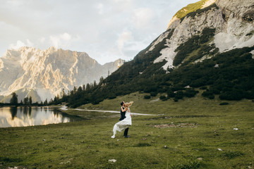 Fototapeta premium Happy bride and groom in the Alps 