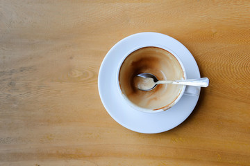 Empty coffee cup after drink on wood table.top view of coffee cup in coffee shop