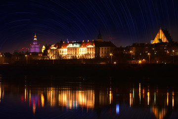 Fototapeta na wymiar Panorama of Warsaw at night - a view over the Vistula River at the Royal Castle