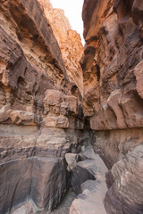 A narrow pass between to gigantic sandstone mountains in the Wadi Rum, Jordan.