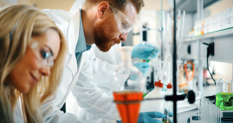 Young students of chemistry working in laboratory