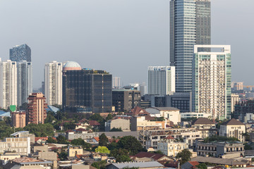 Fototapeta na wymiar Low rise residential district and towers in Jakarta, Indonesia capital city.